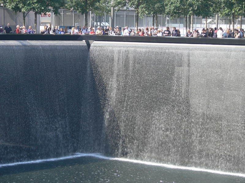 People ring the edge of one of the fountains